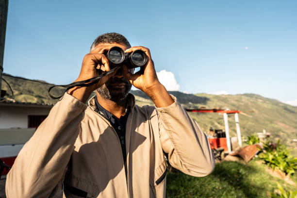 istock Farmer looking at the view through binoculars on a farm in Barbosa, Antioquia 2196796783