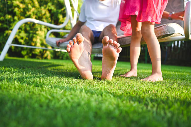 Cute barefoot people on porch swing.