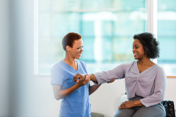 istock Physical Therapist Assisting Patient with Arm Exercises 2196801099