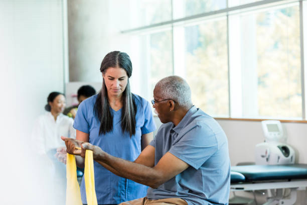 istock Physical Therapist Assisting Senior Patient with Exercises 2196801107