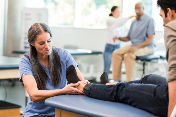 istock Physical Therapist Examining Patient's Foot in Clinic 2196801149