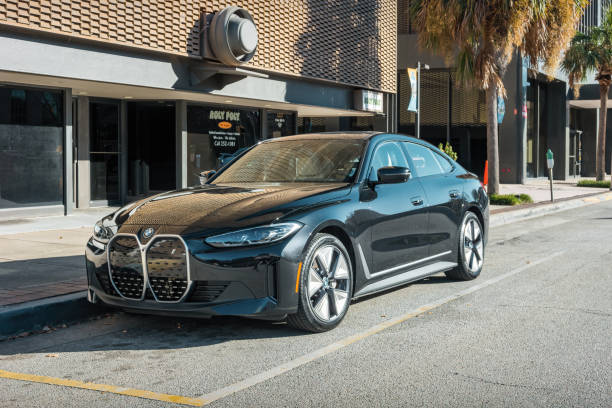 A black colored BMW i4 battery electric vehicle is parked in Columbia, South Carolina, USA on a sunny day.
