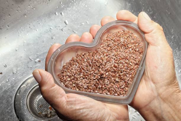 Flax seeds in a heart-shaped container symbolizing love for nature and healthy eating