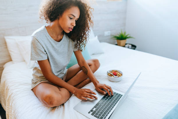 istock Woman writing on laptop at home 2196804978