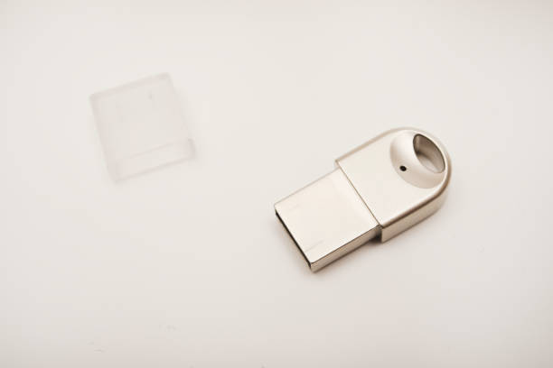 The metal case of the USB adapter. Wi-Fi module on a white background. The Bluetooth adapter's whistle.