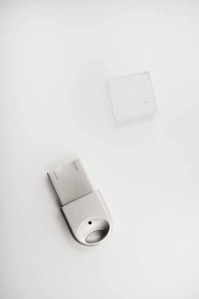 The metal case of the USB adapter. Wi-Fi module on a white background. The Bluetooth adapter's whistle.