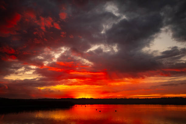 A breathtaking sunset featuring vibrant hues beautifully reflecting off the calm waters, ideal for tranquil themes