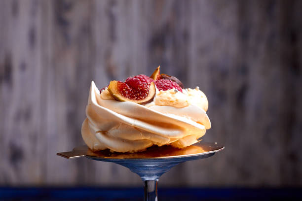 Close up of dessert Pavlova with raspberries and figs