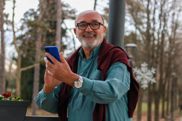 istock Senior man using phone on street 2196810605