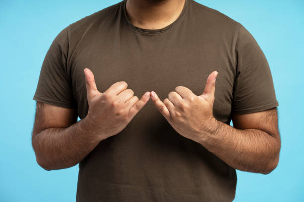 Man making phone gesture with hands and fingers on blue background
