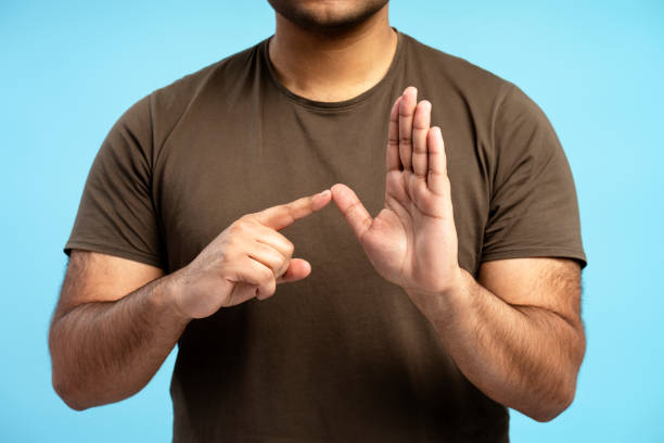 istock Man making letter t with hands in sign language 2196818475