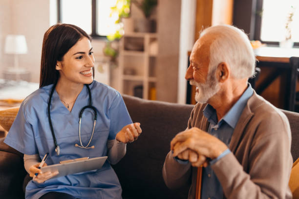 istock Young nurse talking with a senior man holding a walking cane 2196821538