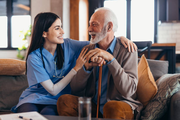 istock Young nurse comforting senior man holding a walking stick 2196821544