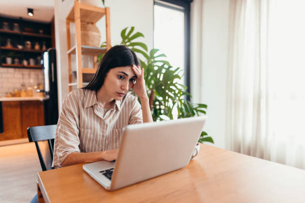 istock Stressed young woman working from home having problems with her laptop 2196821569