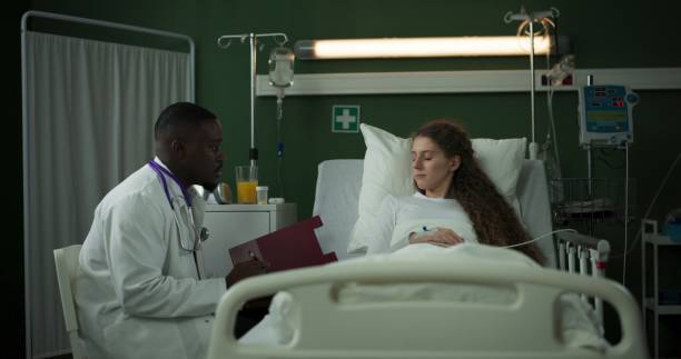 istock Doctor with folder sits next to the patient, sharing important information 2196825965