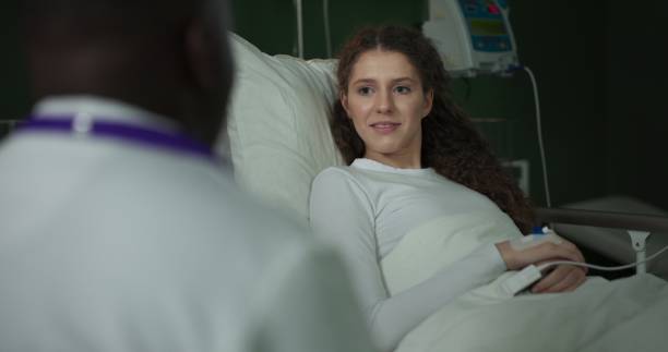 istock Doctor sits by the bed, discussing the patient's progress 2196826034