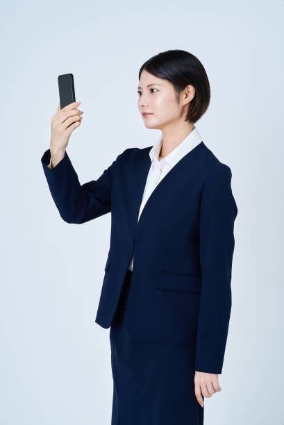 istock A woman in a suit operating a smartphone 2196826971
