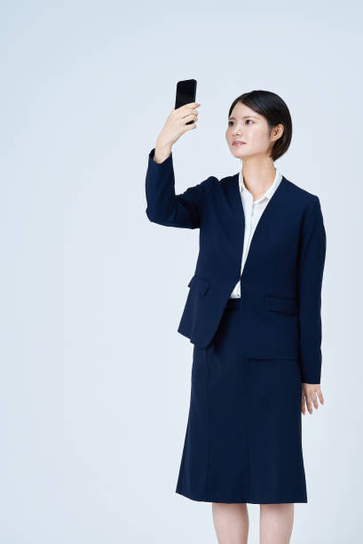 istock A woman in a suit operating a smartphone 2196827015