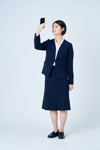 istock A woman in a suit operating a smartphone 2196827084