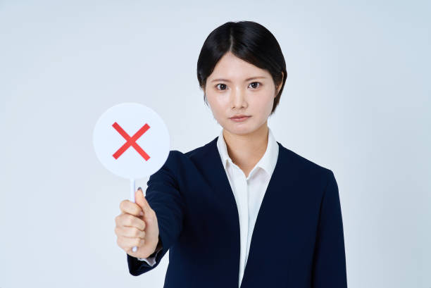 istock A woman in a suit holding a plate with a cross on it 2196827111