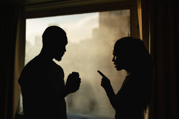 istock Silhouette of a young couple arguing, having relationship problems, marriage issues, alcohol addiction, drinking problem. 2196828936