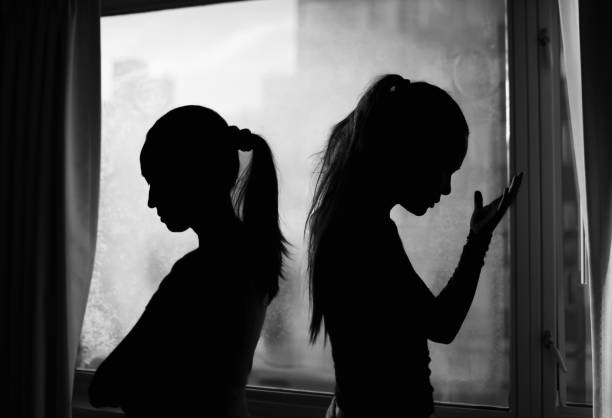 istock Silhouette of two young woman having disagreement, relationship problems. 2196828937