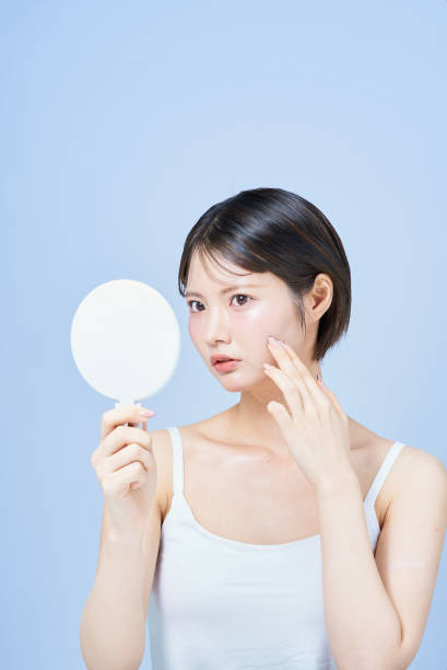 istock Young woman checking her skin condition 2196830123