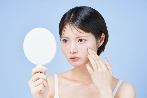 istock Young woman checking her skin condition 2196830147