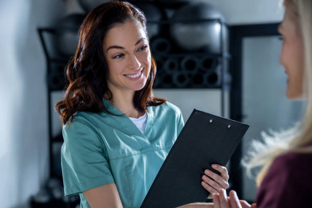 istock Female patient meeting her doctor in clinic and both looking contented 2196830595