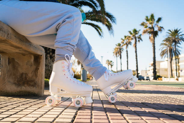 istock Senior woman wearing roller skates sitting on bench in a sunny day 2196830783
