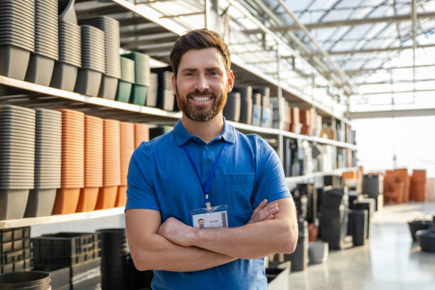 istock Bearded man worker selling pots for plants in warehouse or retail store 2196833819