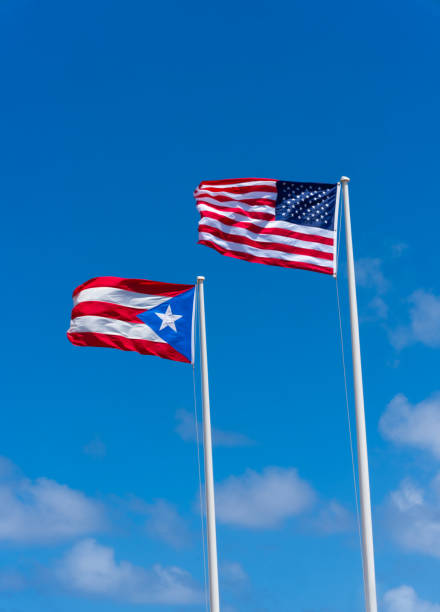 istock Puerto Rican and American Flags against a blue sky 2196834432