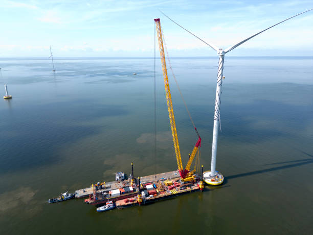 istock A transport ship and crane for constructing an offshore windpark 2196834522
