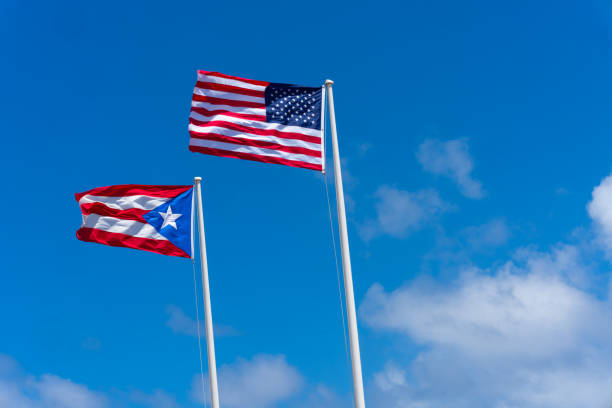 The American and Puerto Rican flags proudly waving atop the Castillo San Cristóbal on a beautiful day.