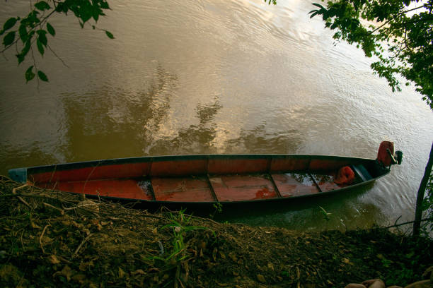 istock Canoe Moored on a Riverbank 2196835424
