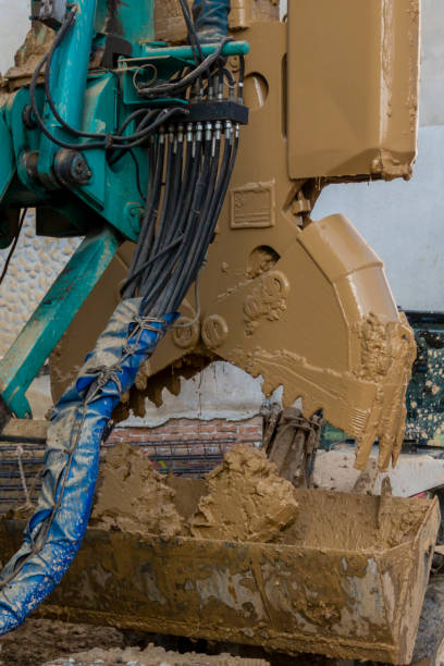 istock Underground diaphragm wall hydraulic grab. Duty cycle crawler crane machine for dredging, dragline operation or foundation work. 2196835881