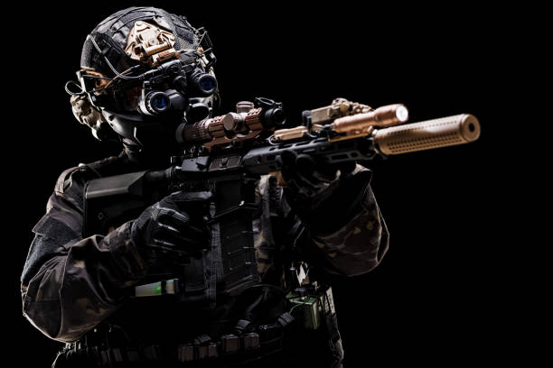 istock Professional soldier in tactical gear aiming a rifle in low light 2196836139