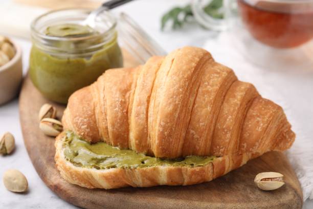 istock Croissant with tasty pistachio cream and nuts on table, closeup 2196837049