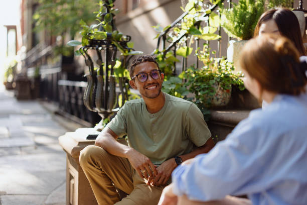 istock Friends Smiling and Conversing Outdoors on a Bright Sunny Day 2196837757