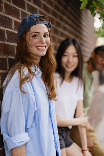 istock Group of Diverse Friends Smiling Outdoors Against a Brick Wall 2196837813