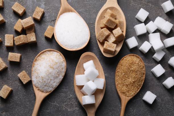 istock Spoons with different types of sugar on gray table, flat lay 2196837897