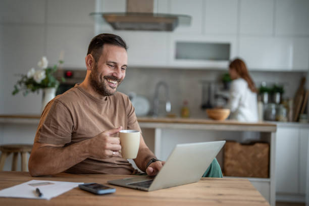 istock Happy man sipping coffee and working on his laptop 2196838328