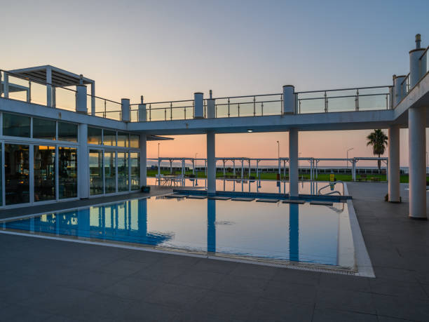 istock Sunset over an elegant poolside area reflecting vibrant hues in a tranquil setting 2196838471