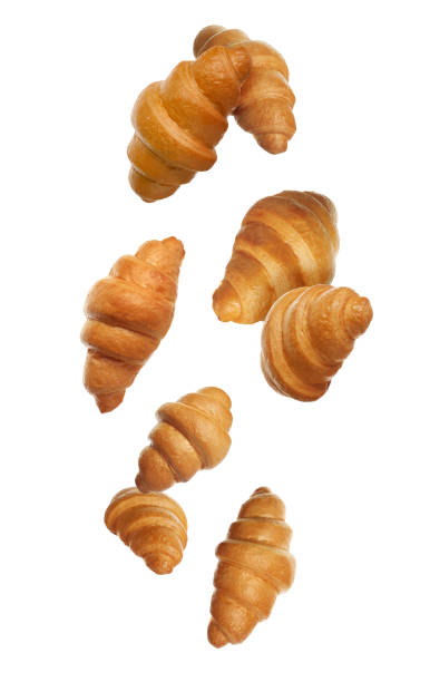 istock Crusty golden croissants falling on white background 2196838996