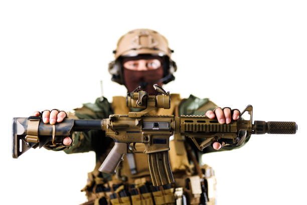 Close-up of a military professional holding a carbine-type firearm, emphasizing equipment and tactical gear, set on an isolated white background, providing a clear view for detailing.