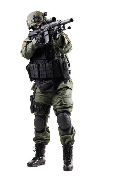istock Tactically Equipped Soldier Posing with Firearm in Defensive Stance on Isolated Background 2196839575