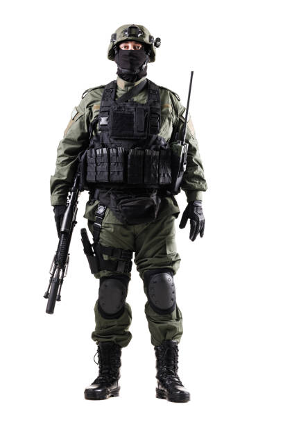 istock Armed Tactical Officer Standing in Protective Gear Holding a Rifle Against a White Background 2196839578