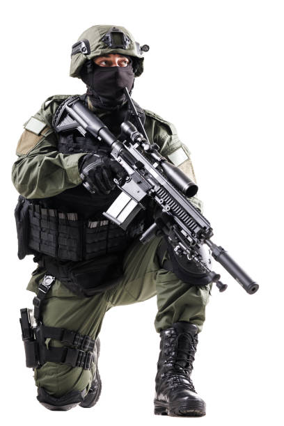 istock Armed tactical officer in specialized uniform holding rifle in a combat pose 2196839584