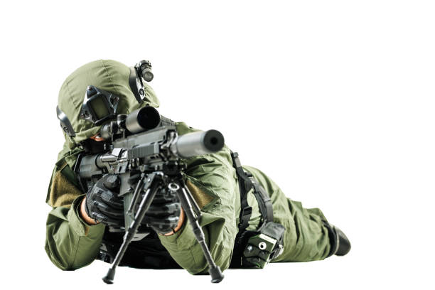 A special forces soldier wearing tactical green uniform while aiming a rifle in a prone position. The image conveys readiness, precision, expertise, and the professionalism of military personnel.