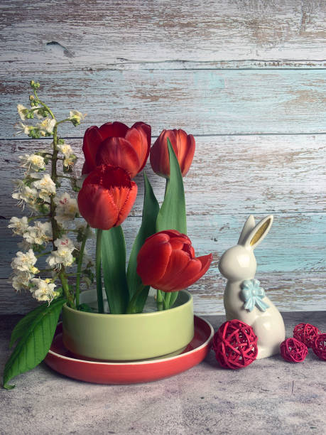spring easter still life with hare, red tulips and blossoming chestnut. High quality photo